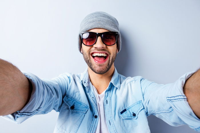 a man in sunglasses demonstrates one of the best selfie poses