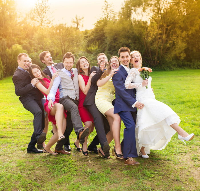 several people posing as part of a wedding party