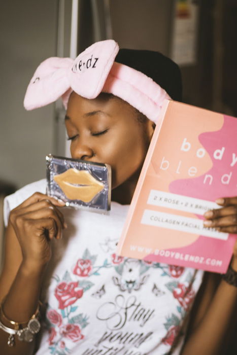 Product photography image of a model with a make-up book and cosmetics case with lips on it