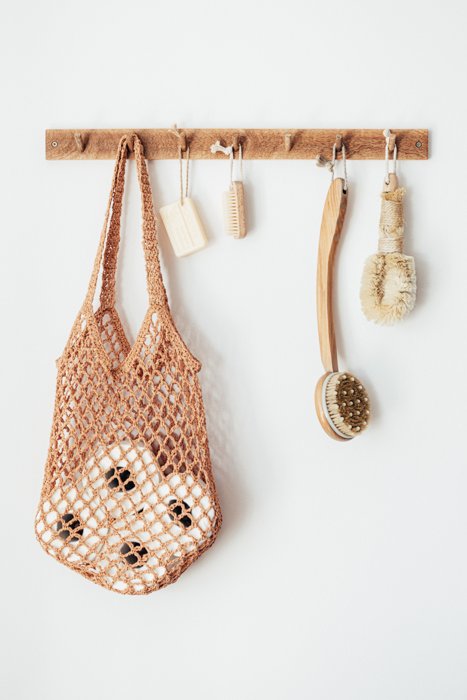 Product photography image of bathroom products hung up on a wooden rack