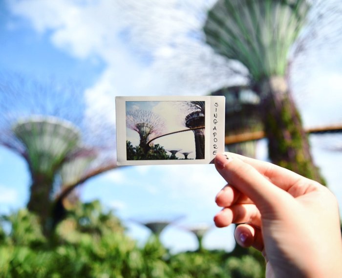 an image of a hand holding an example of a fujifilm instax mini 8 photo from singapore