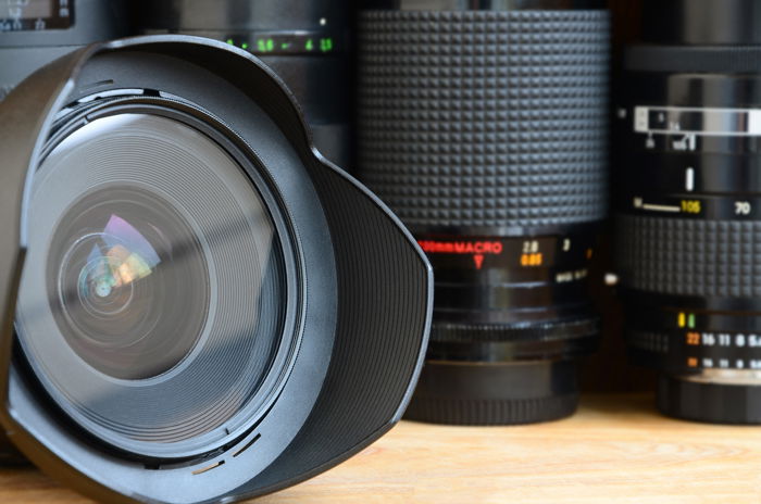 a closeup of a prime lens with a macro lens in the background