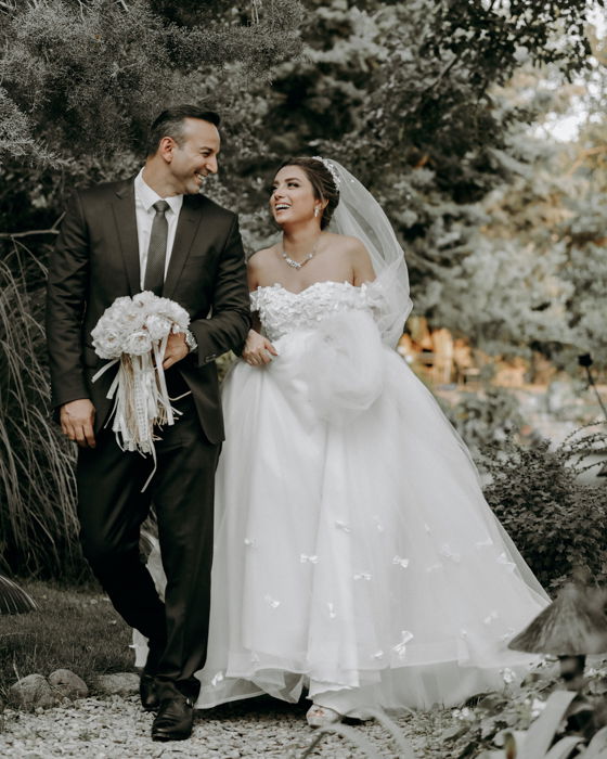 Wedding portrait of the couple walking outdoors