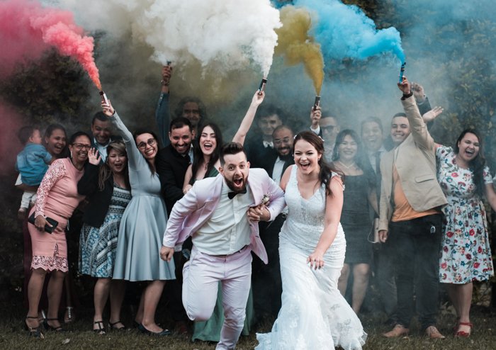 Fun wedding photography group shot with smoke bombs