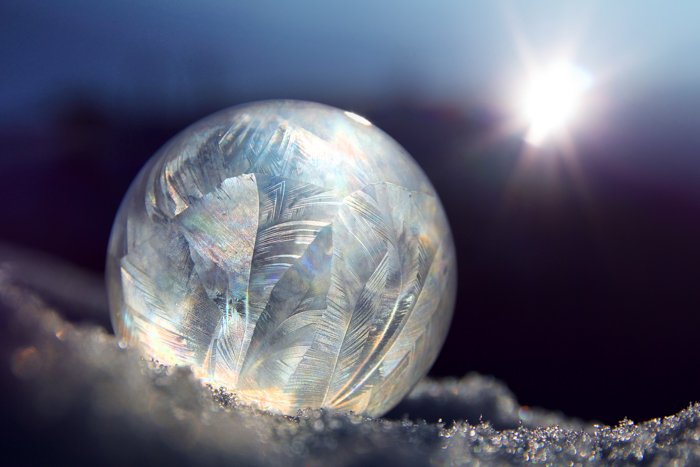 A iridescent bubble on the snow