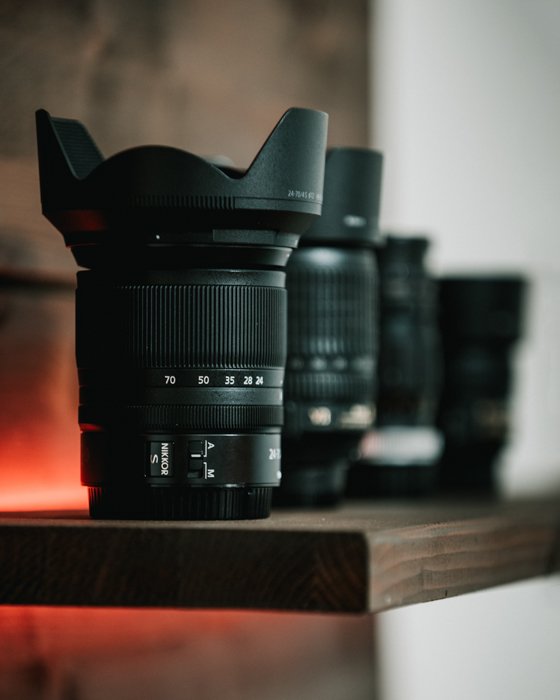 Different camera lenses on a shelf