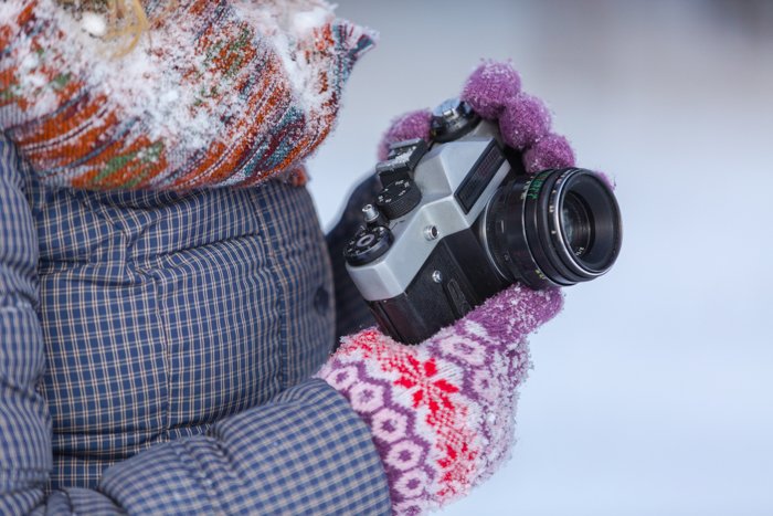 A close up of a photographer shooting snow photos