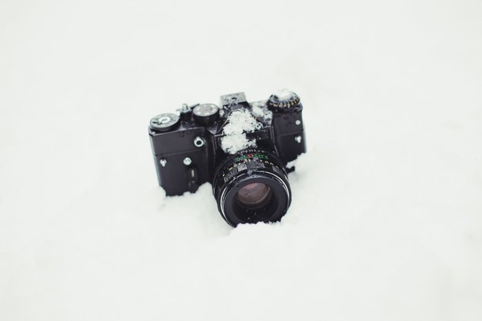 A DSLR camera in the snow