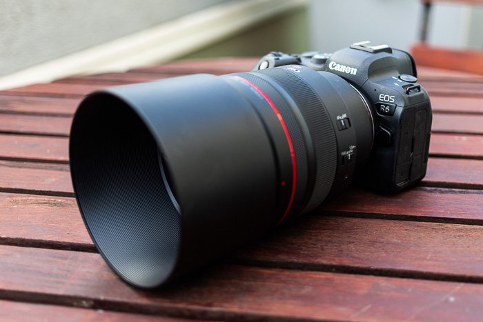 Image of the Canon RF 85mm f/1.2L USM lens with lens hood mounted on a Canon R6
