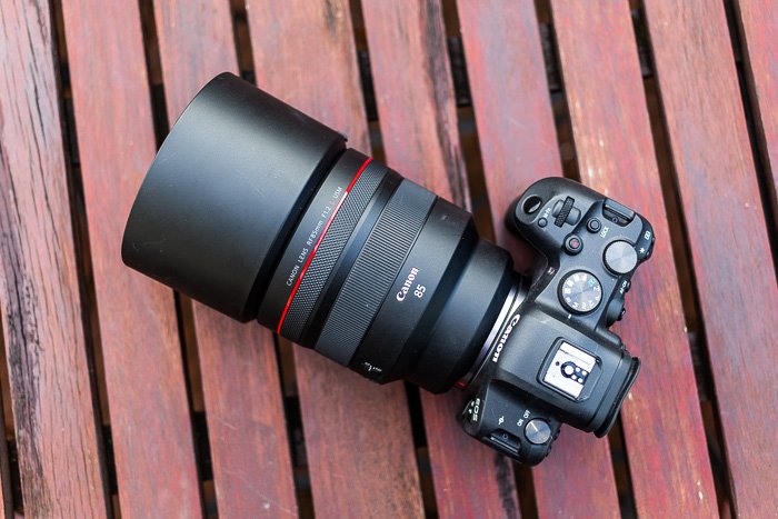 Image of the Canon RF 85mm f/1.2L USM lens with lens hood from above