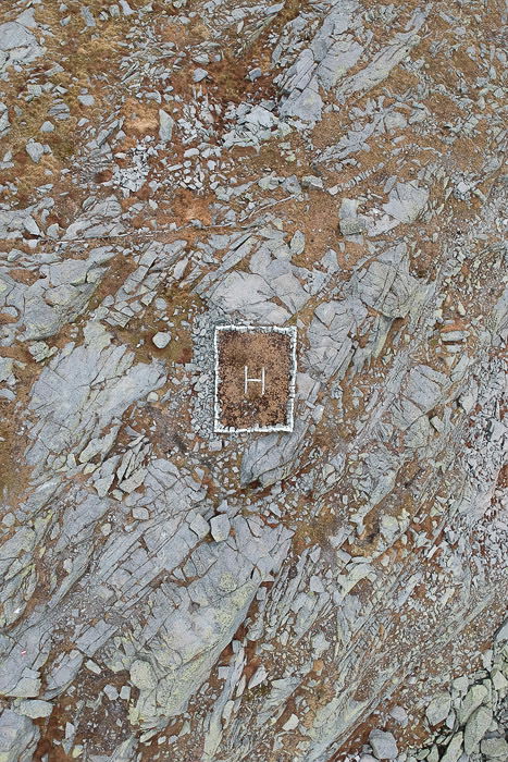 An abstract aerial drone photography of a tomb on a mountainside