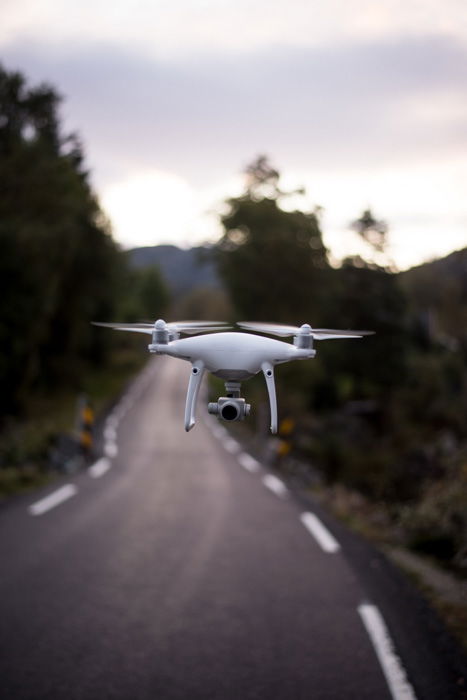 an image of a flying drone above a road