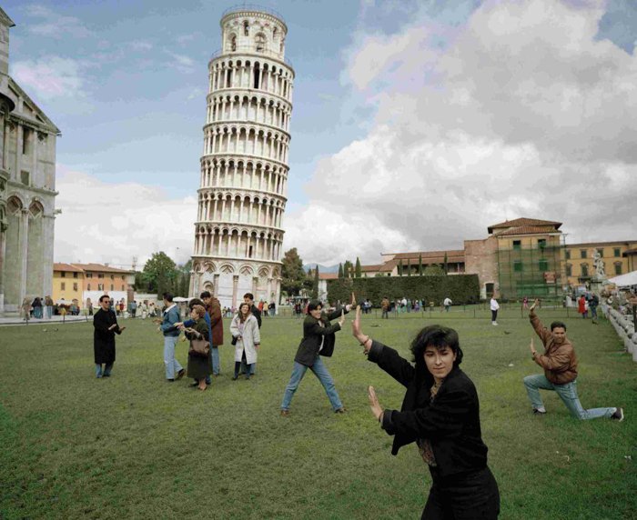 Joke image of people failing to hold up the leaning tower of pisa