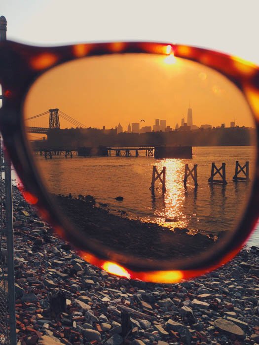 A pretty coastal photo photographed through the lens of a pair of sunglasses