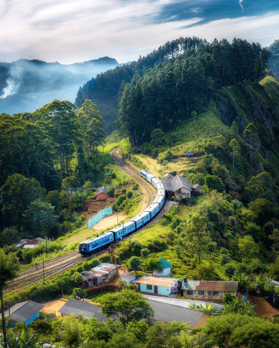 Travel photo of a train moving through a serene landscape