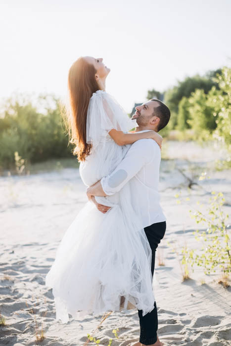 A photograph where the groom lifts up the bride