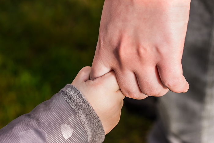 macro family picture of father and son holding hands