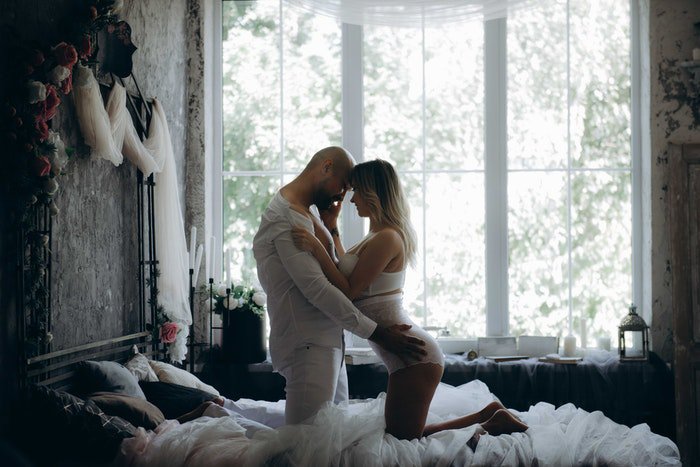 A sexy Valentine's day boudoir photoshoot of a couple on a bed