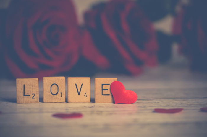 A cute still life photography showing the word love with scrabble cubes.