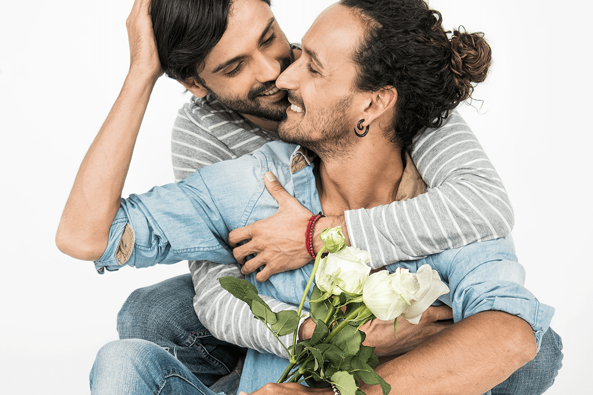 Two men embracing with flowers as a Valentines day photoshoot idea