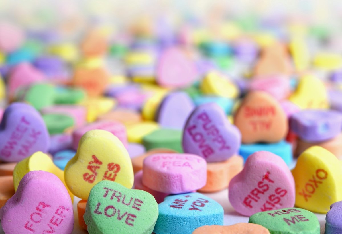 Colorful heart-shaped candy with words on them as a Valentines day photoshoot idea