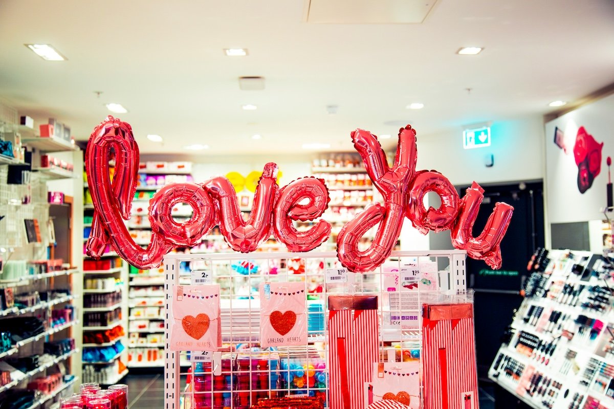 Love you balloons in a stationary store as a Valentines Day photoshoot idea