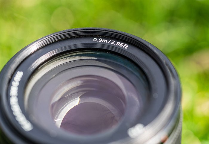 Lens showing minimum focusing distance numbers and letters