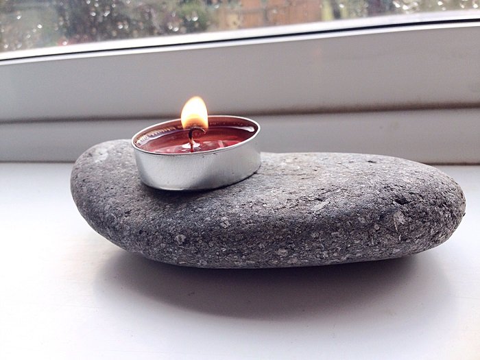 diy product photography of a candle and stone by window lighting