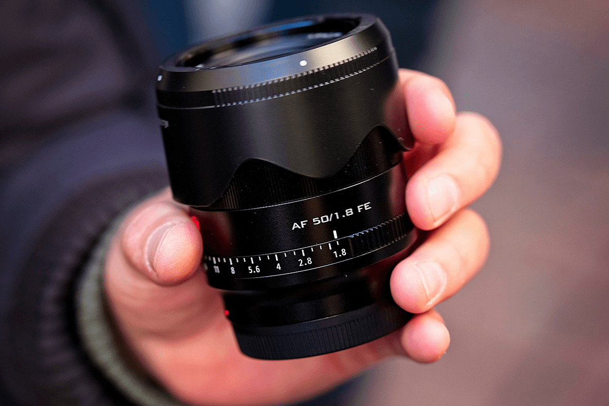 A person holding a nifty fifty lens