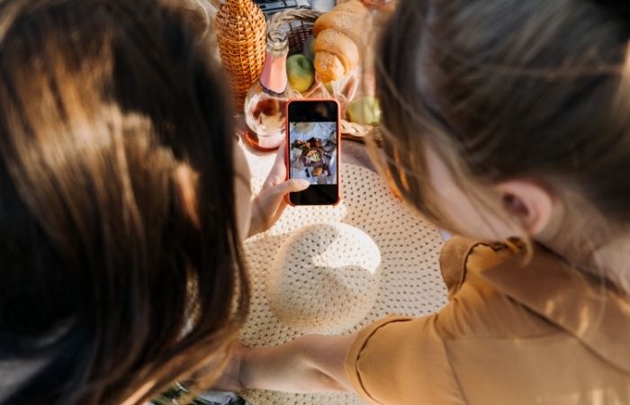 two women looking at a a food photography flat lay image