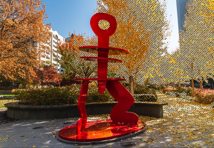 an image of a red sculpture with yellow leaves selected in photoshop