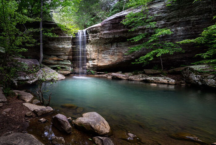 A small hidden waterfall in the wood to show landscape photography settings for blurred water