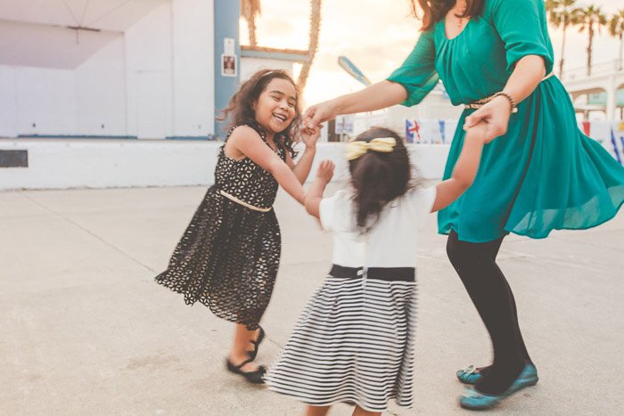 a shot of two children and an adult in a happy pose but with slight motion blur 