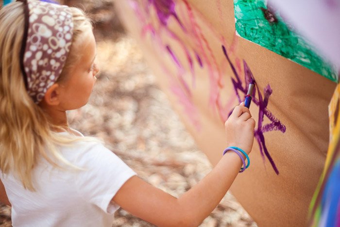 candid child photography of a little girl drawing