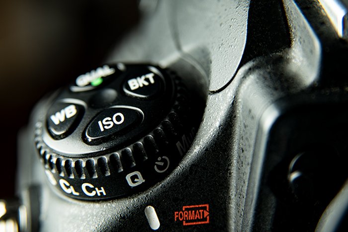 An extreme closeup of a camera's shooting mode dial