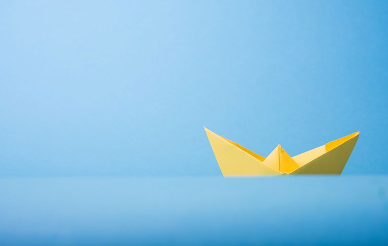 minimalist image of a paper boat