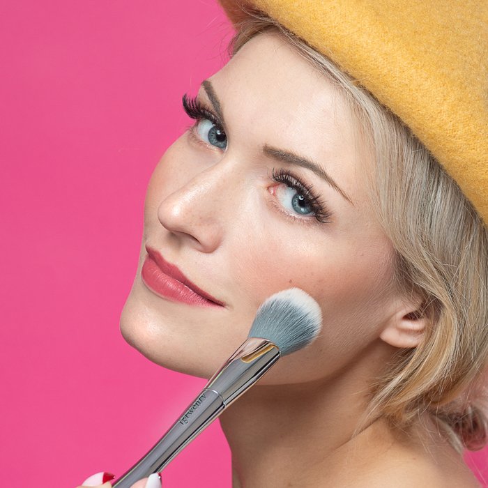 A closeup beauty shot of a woman applying makeup