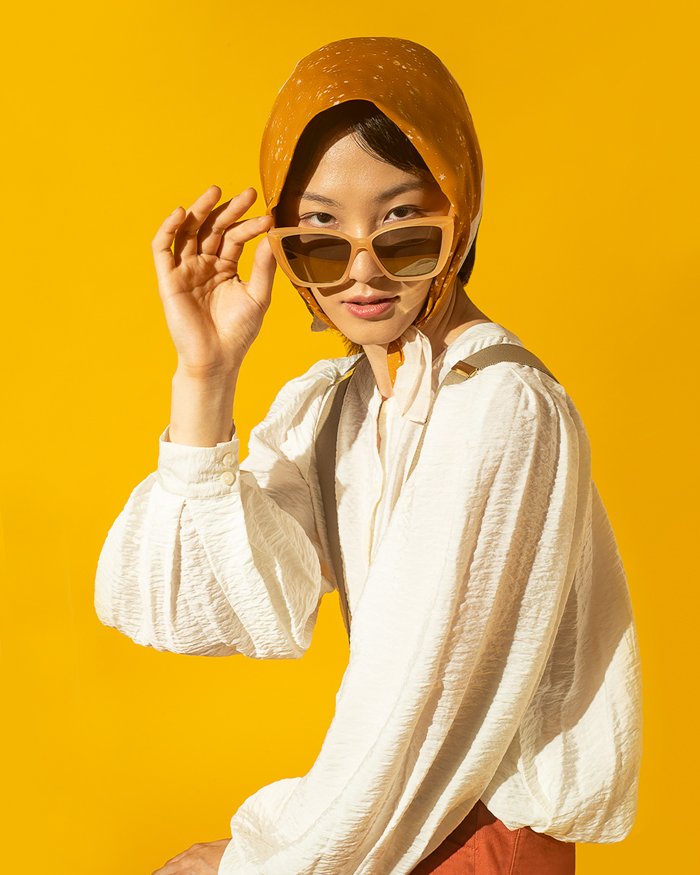 a 3/4 shot of a model against a yellow background