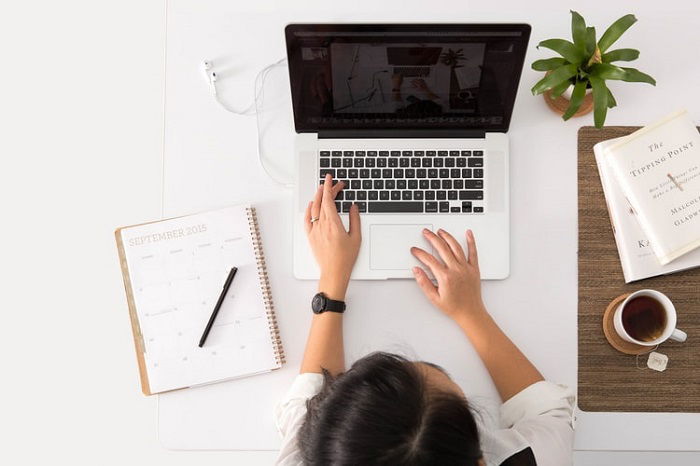 image of a woman using a MacBook