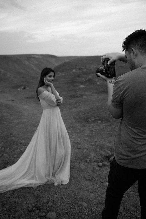 black and white image of a portrait photographer shooting a female model outdoors