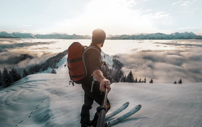 panoramic view of a skiier on a snowy mountain slope taken with a 360 camera