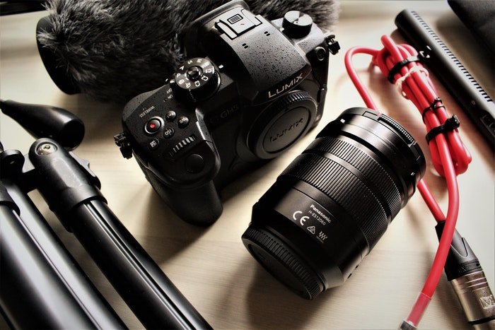 image of photography equipment with a Four Thirds camera, lens, and tripod