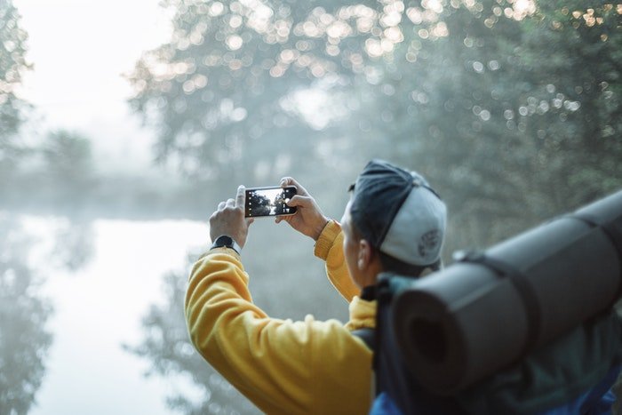 landscape photographer using a smartphone camera
