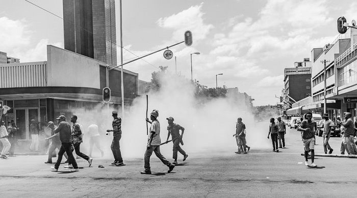 black and white photo of a street protest