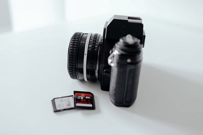 memory cards next to a camera