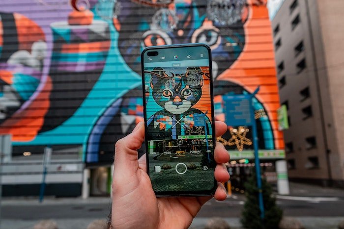 A camera phone taking a picture of a colorful mural for smartphone photography