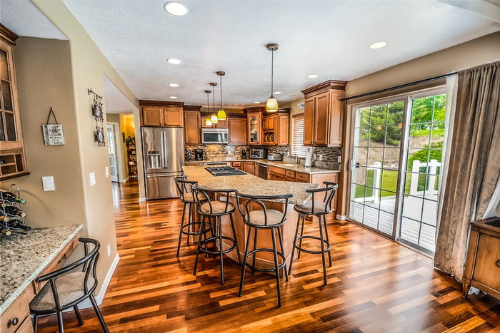 Kitchen interior with wood flooring and cabinets shot for real estate photography