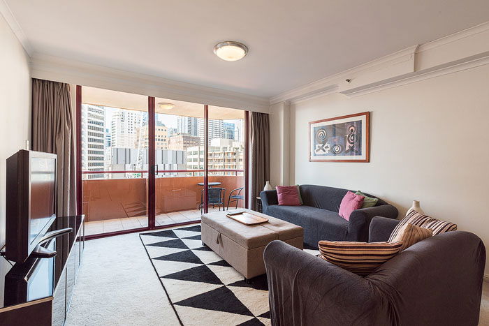 A living room interior with a balcony and a city view shot for how to get into real estate photography