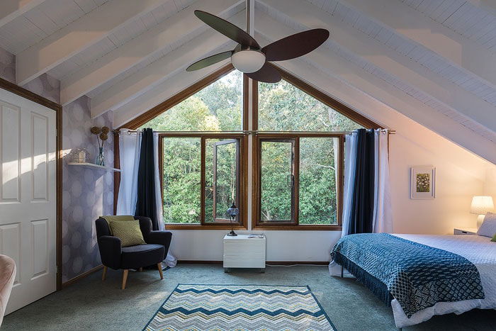 A casual bedroom loft interior with window and a-frame shot by a real estate photographer