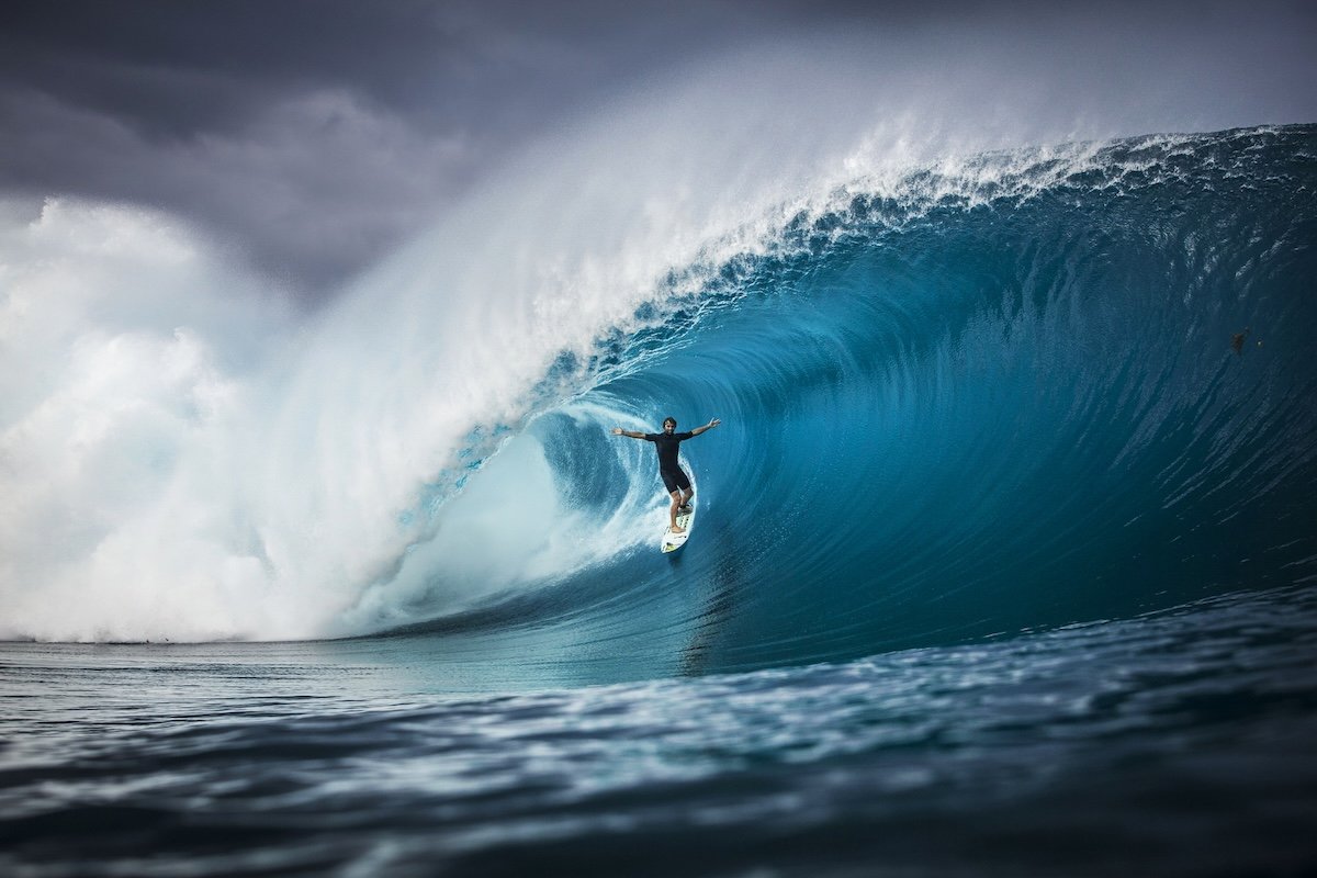 A surfer riding a wave taken by one of the best sports photographers Brent Bielmann